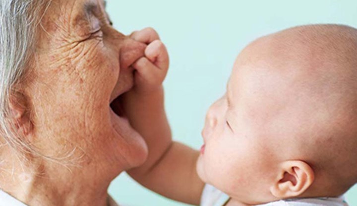 Elderly woman playing with child